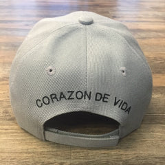 Khaki cap with Corazon de Vida embroidered on the back in black