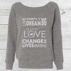 Grey Corazon de Vida sweater that says "give love" and "change lives"