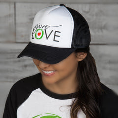 Woman wearing black and white trucker cap with "Give Love" logo