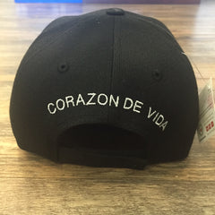 Back of black hat embroidered with Corazon de Vida